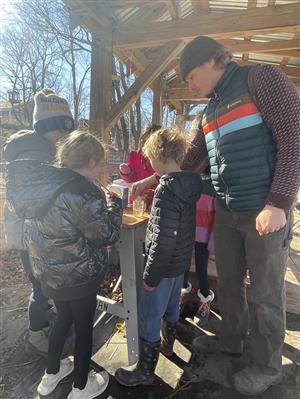 sampling farm fresh syrup made with children during winter program at our farm vegetable washing station.